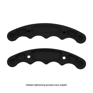 Two black anodized aluminum butterfly wheel grip halves from Pro-Werks, showing contoured finger scallops and hidden lightening pockets machined into the back faces