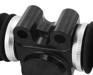 Close-up of a glossy black machined saddle mount block with two bores and a central saddle, flanked by knurled silver collars and padded black arms
